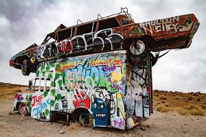 At the International Car Forest of the Last Church, visitors are encouraged to bring paint and add their art to the installation